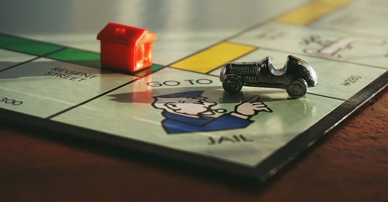 Board Games - Miniature Toy Car on Monopoly Board Game