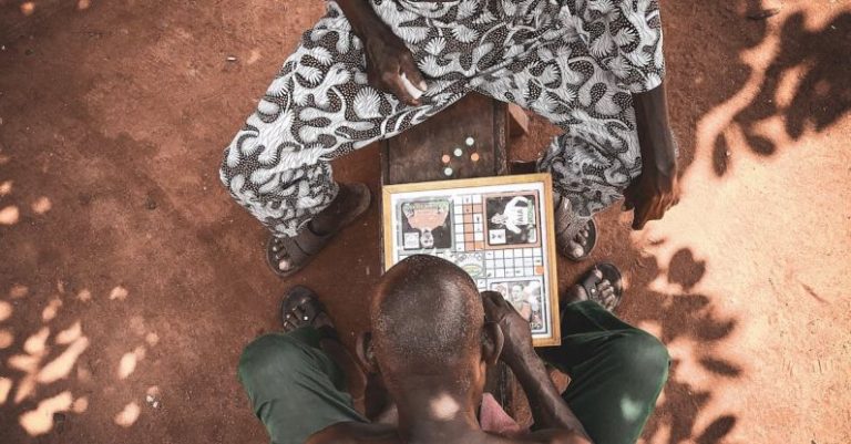 Solo Board Games - Top View Photo Of Men Playing Board Game