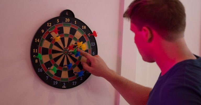 Party Board Game - Man Counting Points From a Dart Game