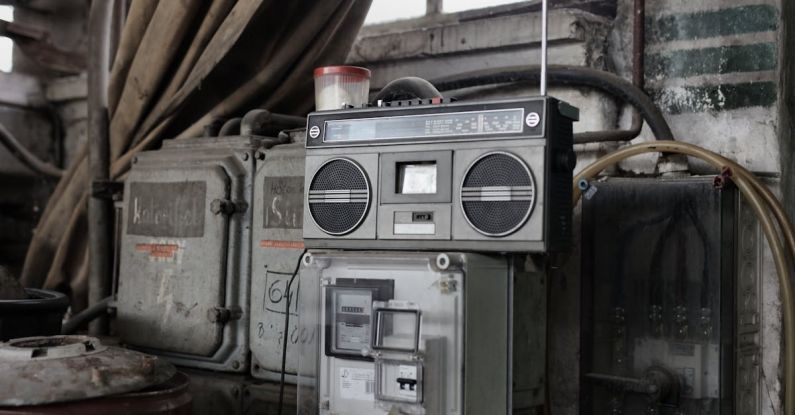 Variable Player Powers - Old fashioned cassette player placed in shabby garage near old industrial equipment