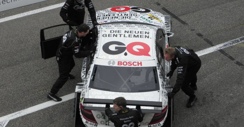 Push-Your-Luck Mechanics - Mechanics Pushing a Race Car