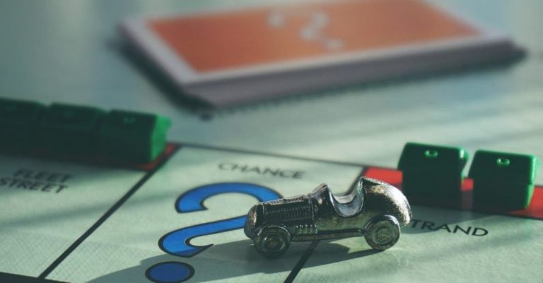 Board Game - Miniature Toy Car on Top of Board Game